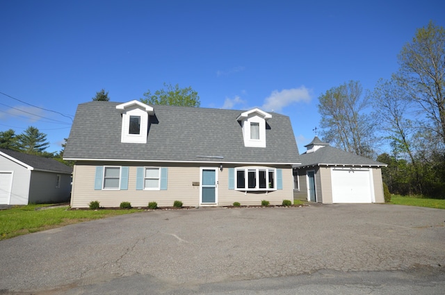 42 Blanchard St, Bangor, ME 04401 - view of front facade with an outdoor structure, asphalt driveway, and roof with shingles