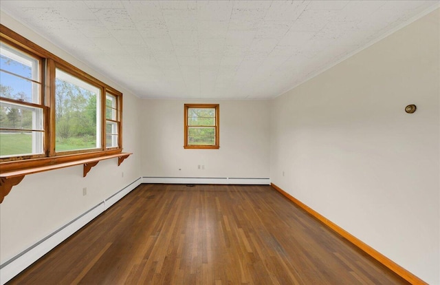 626 Main Rd, Eddington, ME 04428 - spare room featuring dark wood finished floors, baseboard heating, crown molding, and baseboards