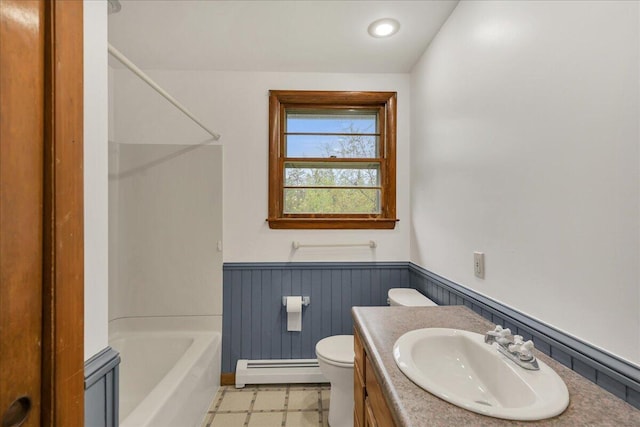 626 Main Rd, Eddington, ME 04428 - bathroom featuring a baseboard radiator, a wainscoted wall, toilet, vanity, and bathing tub / shower combination