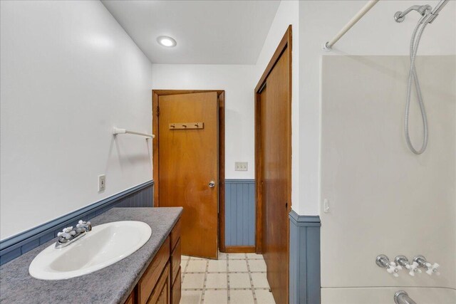 626 Main Rd, Eddington, ME 04428 - bathroom with a wainscoted wall, tile patterned floors, and vanity