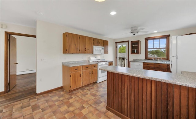 626 Main Rd, Eddington, ME 04428 - kitchen featuring white appliances, a sink, light countertops, recessed lighting, and a ceiling fan