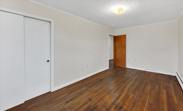 626 Main Rd, Eddington, ME 04428 - unfurnished bedroom with wood finished floors, ornamental molding, baseboards, and a closet