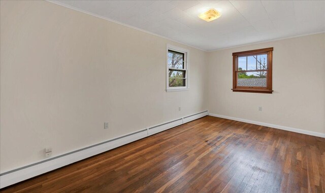 626 Main Rd, Eddington, ME 04428 - spare room with a baseboard heating unit, healthy amount of natural light, hardwood / wood-style flooring, baseboards, and crown molding