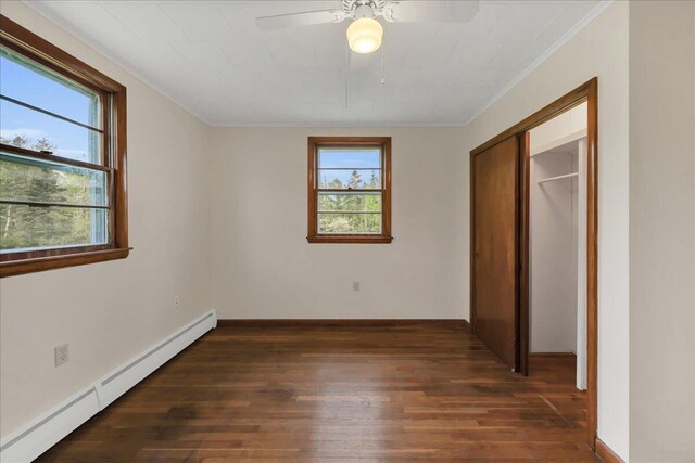 626 Main Rd, Eddington, ME 04428 - unfurnished bedroom with a baseboard heating unit, hardwood / wood-style flooring, crown molding, baseboards, and a ceiling fan