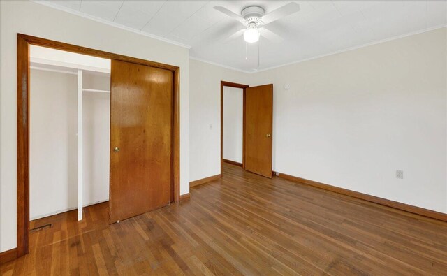 626 Main Rd, Eddington, ME 04428 - unfurnished bedroom featuring wood finished floors, crown molding, baseboards, a closet, and ceiling fan