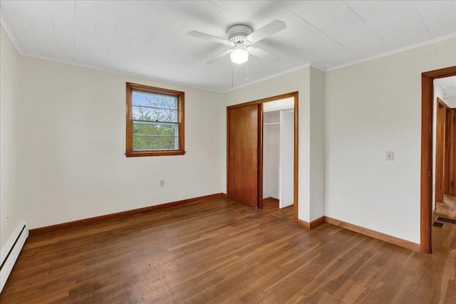 626 Main Rd, Eddington, ME 04428 - unfurnished bedroom featuring a baseboard radiator, wood finished floors, baseboards, a closet, and a ceiling fan