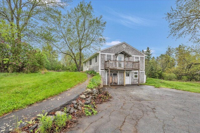 626 Main Rd, Eddington, ME 04428 - view of front facade with a front lawn, asphalt driveway, and a wooden deck