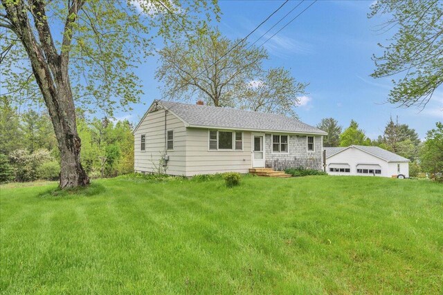 626 Main Rd, Eddington, ME 04428 - view of front of home featuring a front yard, a garage, and roof with shingles