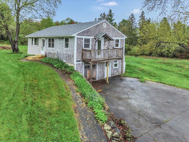 626 Main Rd, Eddington, ME 04428 - view of front of property featuring a front lawn, roof with shingles, and a deck