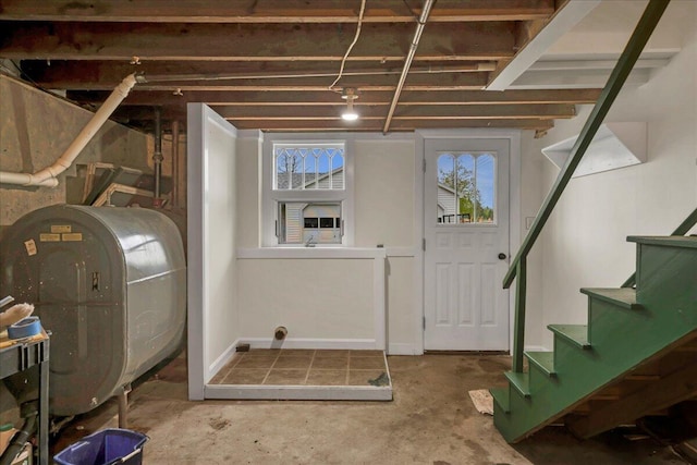 626 Main Rd, Eddington, ME 04428 - below grade area featuring oil tank, healthy amount of natural light, and stairs