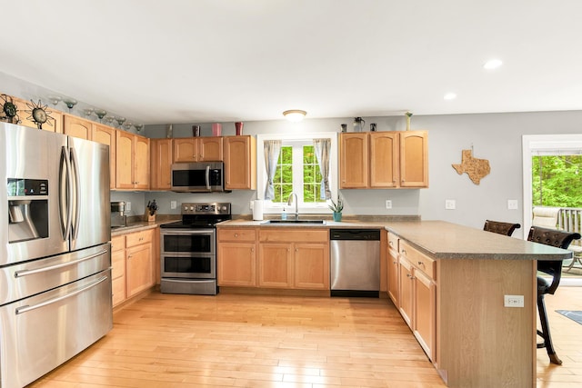 77 Cemetery Rd, Berwick, ME 03901 - kitchen with appliances with stainless steel finishes, a sink, a peninsula, light brown cabinetry, and recessed lighting