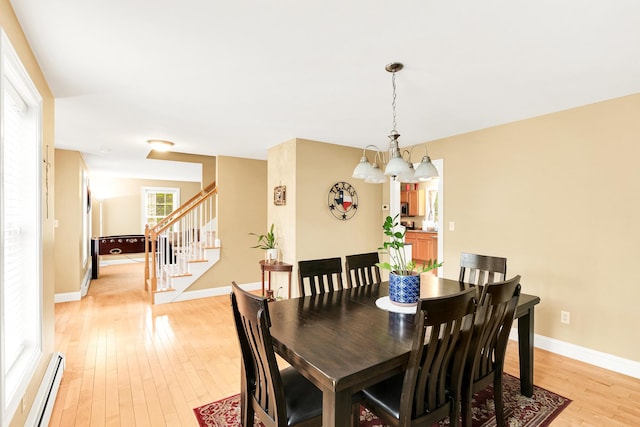 77 Cemetery Rd, Berwick, ME 03901 - dining space featuring a baseboard heating unit, a chandelier, light wood finished floors, stairway, and baseboards