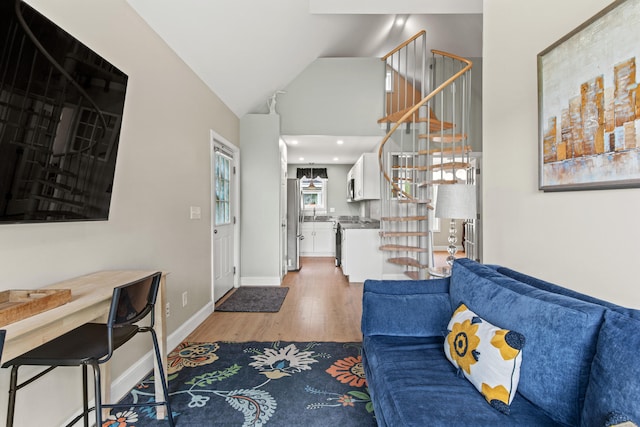 994 Portland Rd Unit 30, Saco, ME 04072 - living room with light wood-type flooring, stairway, lofted ceiling, and baseboards