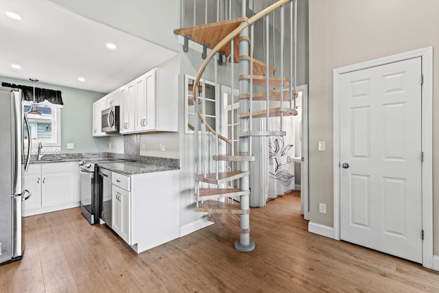 994 Portland Rd Unit 30, Saco, ME 04072 - kitchen with stainless steel appliances, light wood-style flooring, white cabinets, dark stone counters, and recessed lighting