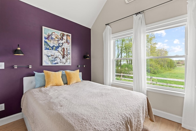 994 Portland Rd Unit 30, Saco, ME 04072 - bedroom with baseboards, light wood-style flooring, and vaulted ceiling