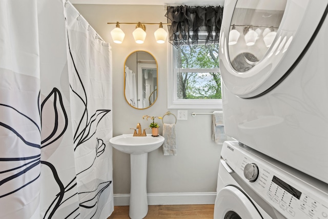 994 Portland Rd Unit 30, Saco, ME 04072 - bathroom with stacked washer / drying machine, baseboards, a sink, wood finished floors, and a shower with shower curtain