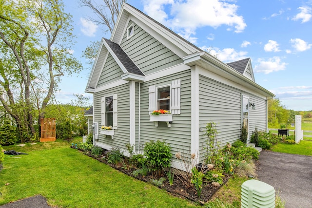 994 Portland Rd Unit 30, Saco, ME 04072 - view of home's exterior featuring a lawn and roof with shingles