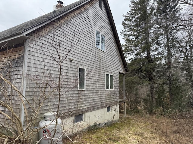82 Taber Ln, Corinth, ME 04427 - view of side of home featuring a chimney