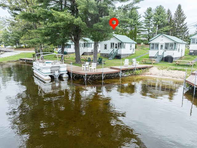 750 Roosevelt Trl Unit 7, Naples, ME 04055 - dock area featuring stairs, a water view, and a lawn