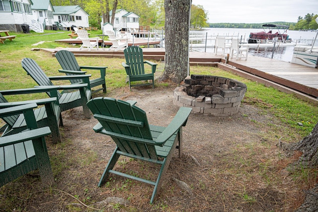 750 Roosevelt Trl Unit 7, Naples, ME 04055 - view of patio / terrace featuring a fire pit, a deck with water view, and a dock