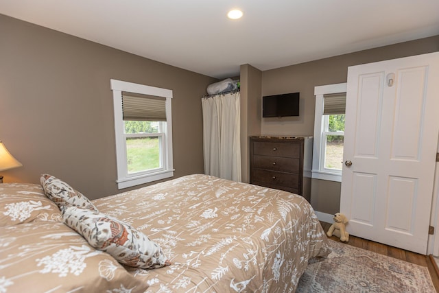 750 Roosevelt Trl Unit 7, Naples, ME 04055 - bedroom with wood finished floors, multiple windows, baseboards, and recessed lighting