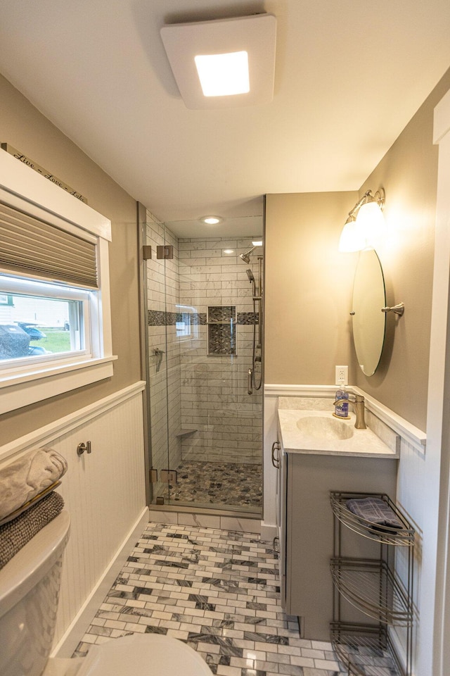 750 Roosevelt Trl Unit 7, Naples, ME 04055 - bathroom with toilet, a shower stall, a wainscoted wall, and vanity