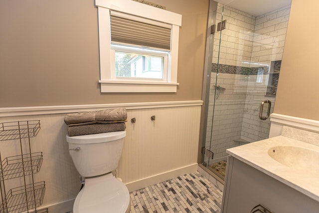 750 Roosevelt Trl Unit 7, Naples, ME 04055 - bathroom with wainscoting, a shower stall, vanity, and toilet