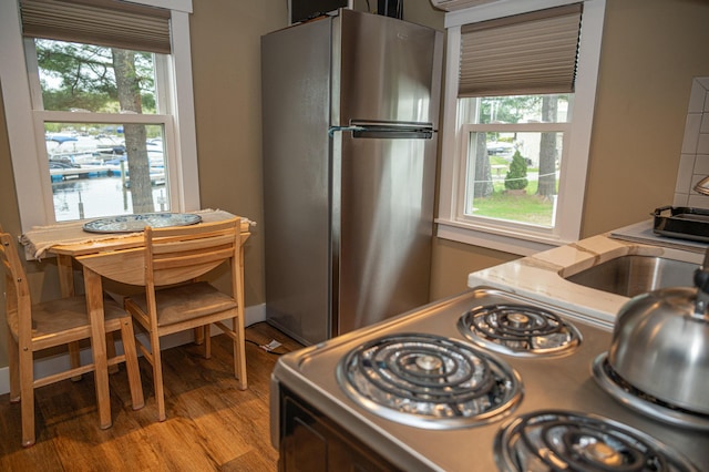 750 Roosevelt Trl Unit 7, Naples, ME 04055 - kitchen featuring freestanding refrigerator, light wood-style flooring, electric stove, and healthy amount of natural light