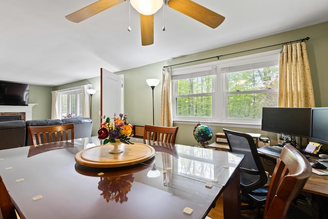455 Duck Pond Rd, Westbrook, ME 04092 - dining area featuring a ceiling fan, a brick fireplace, and an office area