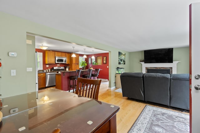 455 Duck Pond Rd, Westbrook, ME 04092 - living room with light wood finished floors and a brick fireplace