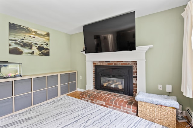 455 Duck Pond Rd, Westbrook, ME 04092 - living area featuring a fireplace, baseboards, wood finished floors, and a baseboard heating unit