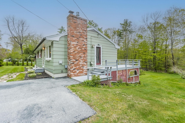 455 Duck Pond Rd, Westbrook, ME 04092 - view of side of property with a lawn, a chimney, and a wooden deck