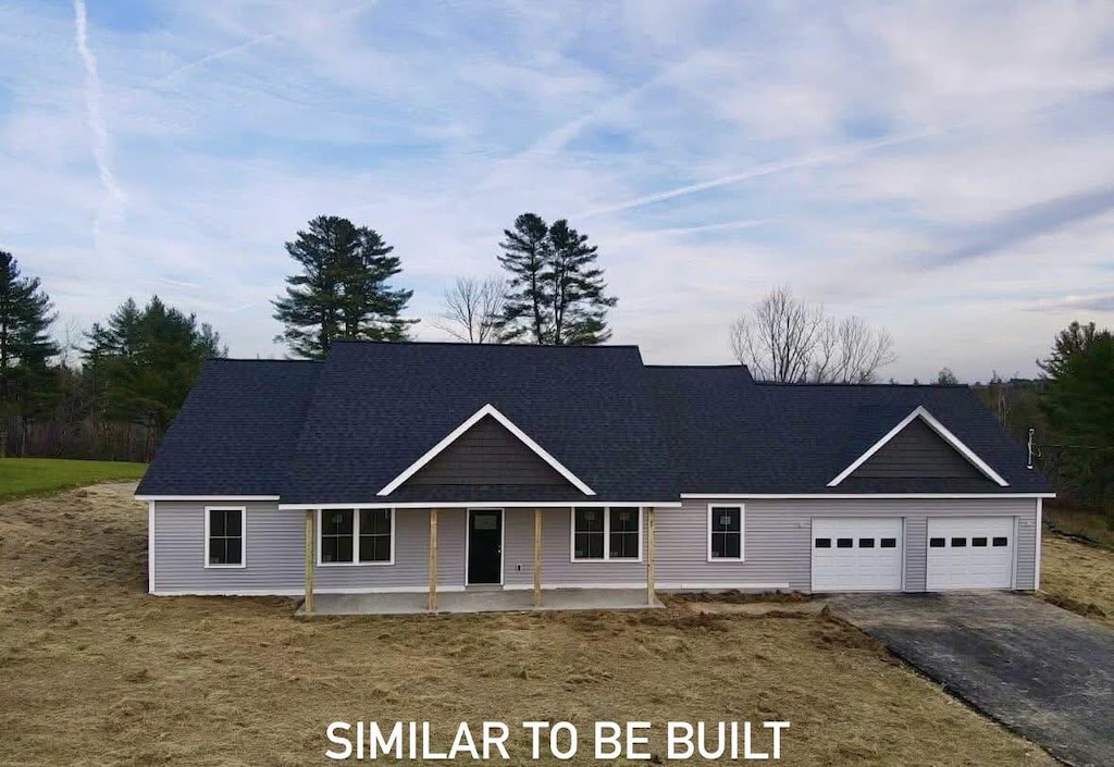 68 Bean Ests, Bangor, ME 04401 - view of front of house with asphalt driveway, a garage, and a front yard