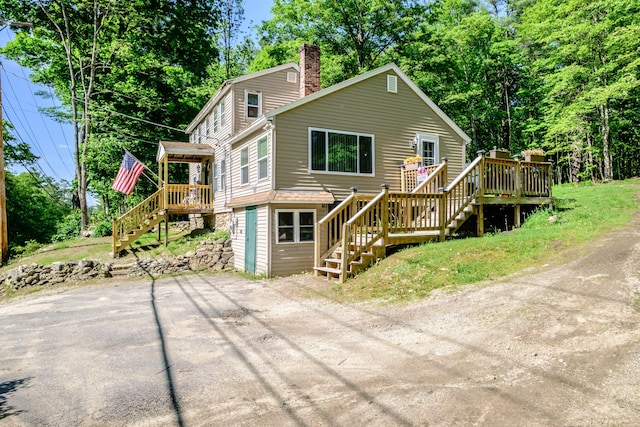 148 Naples Rd, Harrison, ME 04040 - rear view of property featuring stairs, a chimney, and a deck