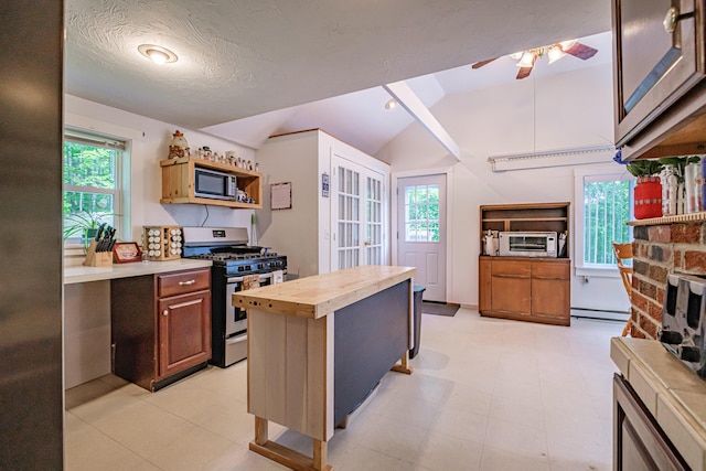 148 Naples Rd, Harrison, ME 04040 - kitchen with stainless steel appliances, butcher block countertops, vaulted ceiling, ceiling fan, and plenty of natural light