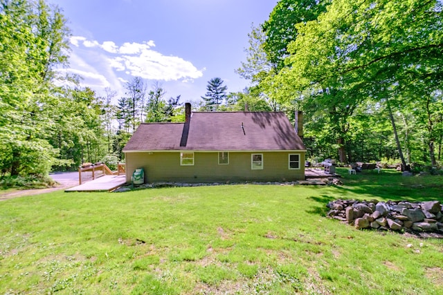 148 Naples Rd, Harrison, ME 04040 - back of house featuring a chimney, a wooden deck, and a yard