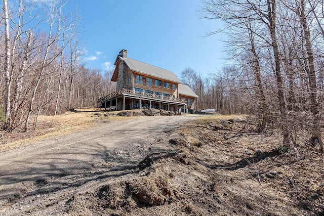 6065 Sandy River Cir, Carrabassett Valley, ME 04947 - rear view of property with a chimney and driveway