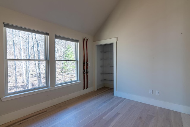 6065 Sandy River Cir, Carrabassett Valley, ME 04947 - unfurnished room with light wood finished floors, baseboards, and high vaulted ceiling