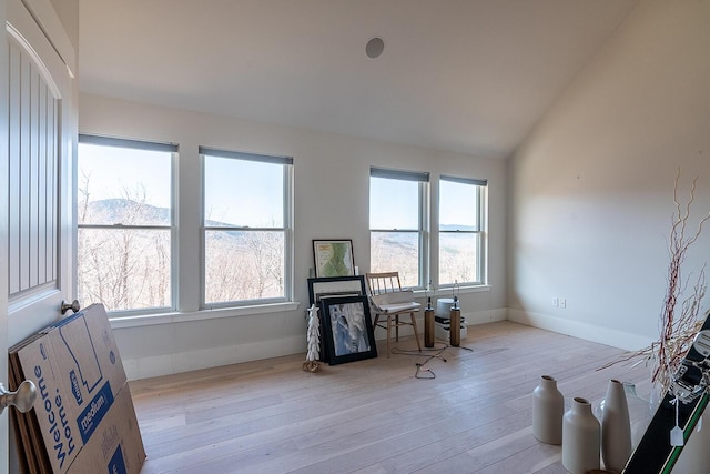 6065 Sandy River Cir, Carrabassett Valley, ME 04947 - office with plenty of natural light, light wood-style flooring, vaulted ceiling, baseboards, and a fireplace