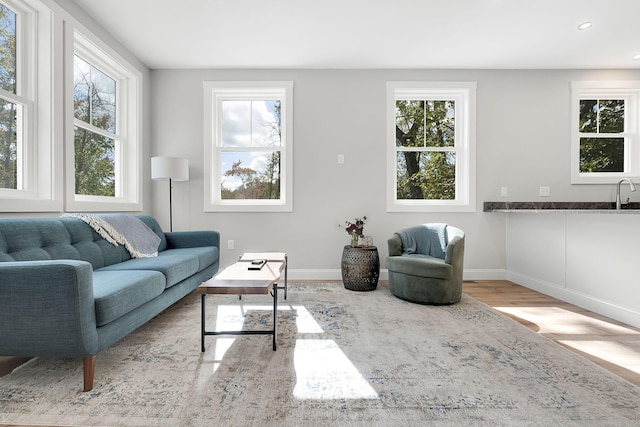 14 Depot St, Buxton, ME 04093 - living area with healthy amount of natural light, wood finished floors, baseboards, and recessed lighting