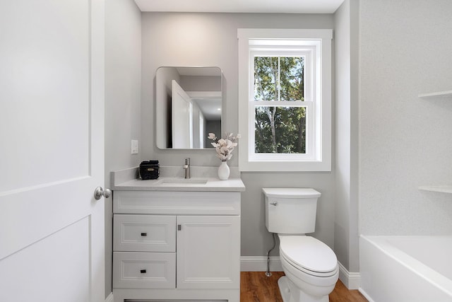 14 Depot St, Buxton, ME 04093 - full bathroom with toilet, wood finished floors, vanity, a tub, and baseboards
