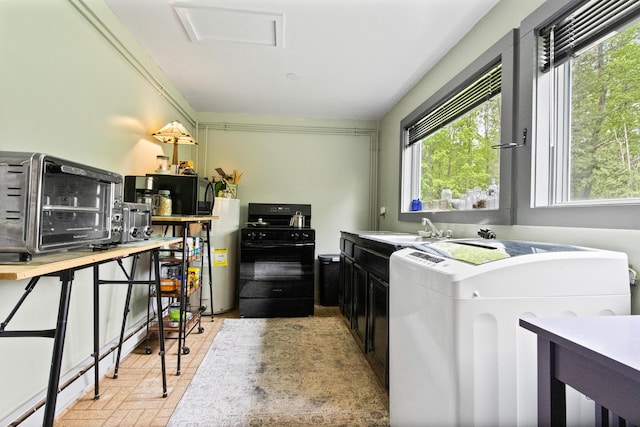 151 Central Ave, Portland, ME 04108 - kitchen featuring black range with gas stovetop, a sink, washer / dryer, dark cabinets, and brick patterned flooring