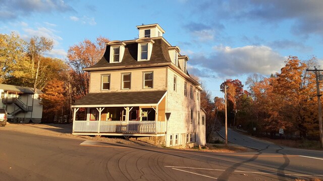 3 Center Hill Rd, Weld, ME 04285 - victorian home featuring a porch, mansard roof, and roof with shingles