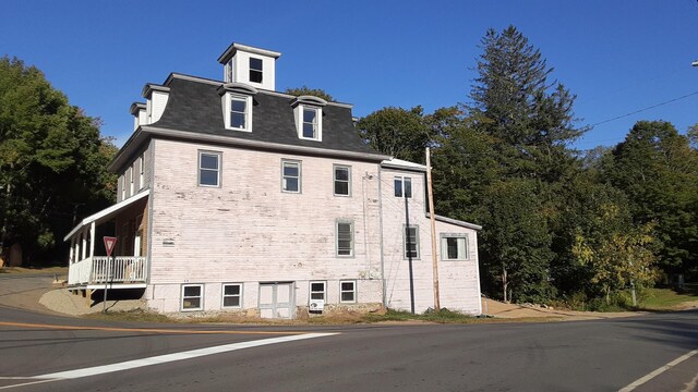 3 Center Hill Rd, Weld, ME 04285 - view of property exterior featuring mansard roof, a shingled roof, and brick siding