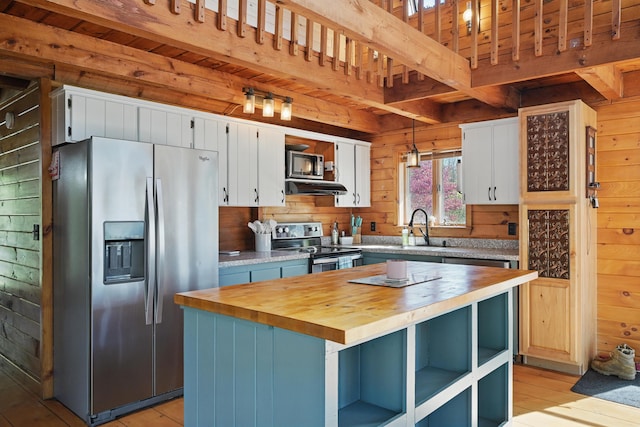 658 High St, West Gardiner, ME 04345 - kitchen featuring appliances with stainless steel finishes, butcher block countertops, a sink, beam ceiling, and open shelves