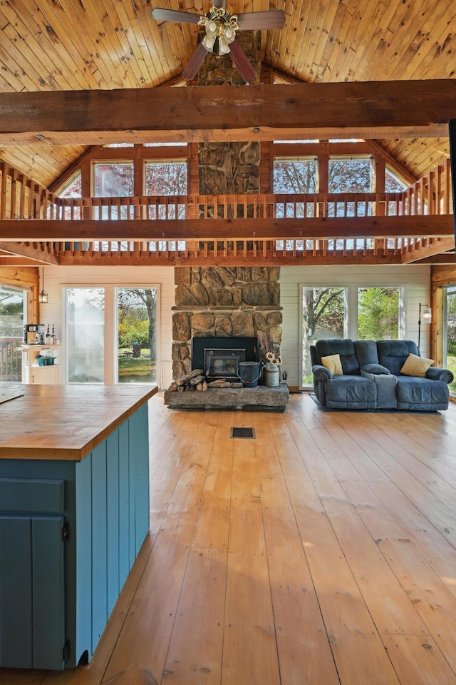 658 High St, West Gardiner, ME 04345 - living area with beamed ceiling, wooden ceiling, a ceiling fan, hardwood / wood-style flooring, and a fireplace