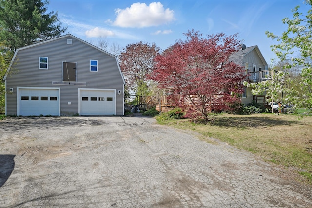 658 High St, West Gardiner, ME 04345 - view of home's exterior featuring a gambrel roof, a garage, and a wooden deck