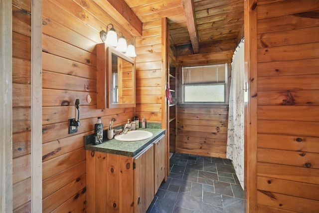 658 High St, West Gardiner, ME 04345 - bathroom featuring wooden ceiling, stone finish floors, wooden walls, vanity, and beam ceiling