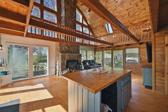 658 High St, West Gardiner, ME 04345 - kitchen featuring wood counters, hardwood / wood-style flooring, beam ceiling, open floor plan, and high vaulted ceiling