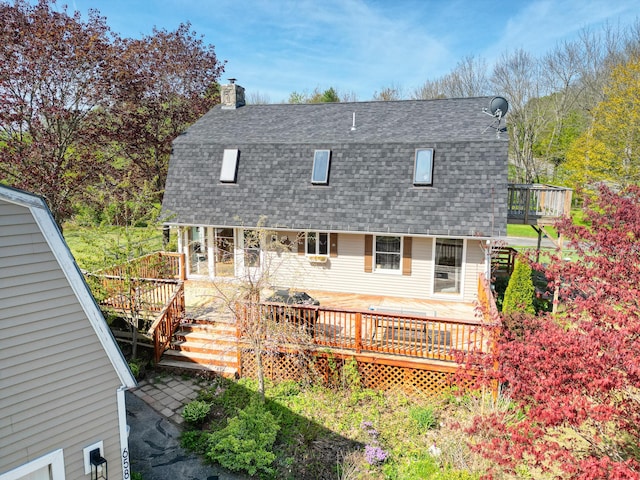 658 High St, West Gardiner, ME 04345 - back of property with a shingled roof, a gambrel roof, a chimney, and a wooden deck